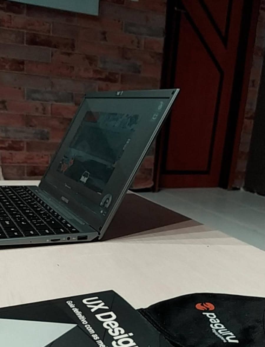 Laptop and the book UX Design on a desk at Paguru